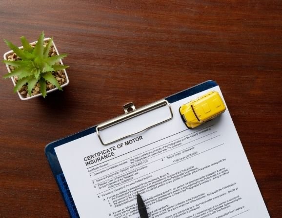 Documents labeled flood insurance renewal left on desk